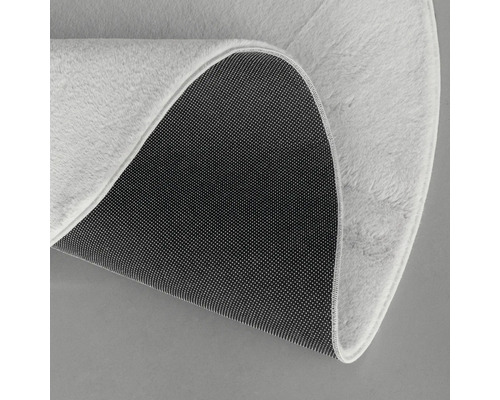 Detaliu covor rotund cu fibre și spate antiderapant