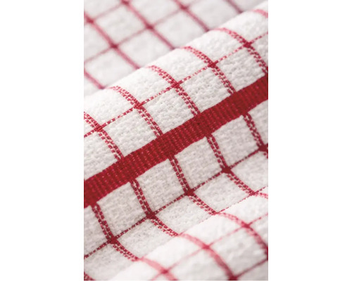Prim-plan cu un prosop de bucătărie în carouri, din bumbac texturat, cu un model de grilă roșie și o dungă roșie groasă.