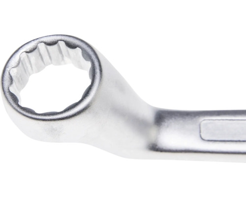 Vedere de aproape a unei chei inelare din metal cromat cu profil dodecagonal.