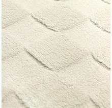Suprafață moale și pufoasă, cu un model geometric în relief.