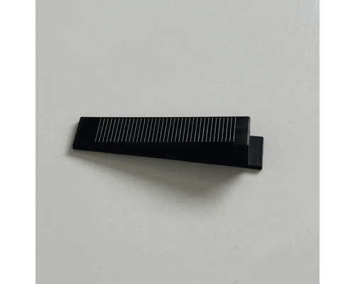 Pană din plastic negru pentru sistem de nivelare cu suprafață striată.