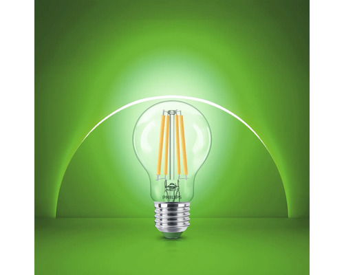 Bec cu filament LED Philips cu dulie E27 și formă transparentă din sticlă.