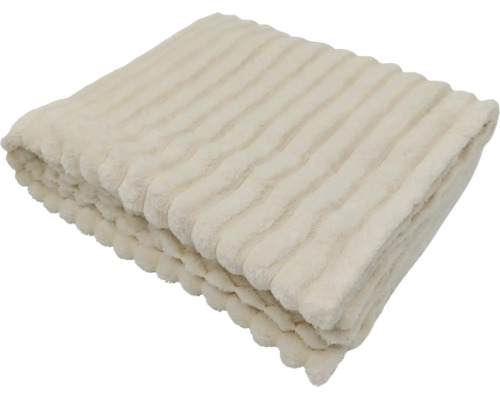 O pătură moale cu structură în dungi, pliată ca material textil decorativ pentru casă.