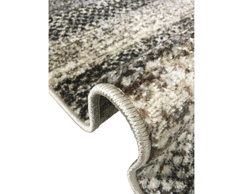 Vizualizare detaliată a unui covor cu model cu margini festonate