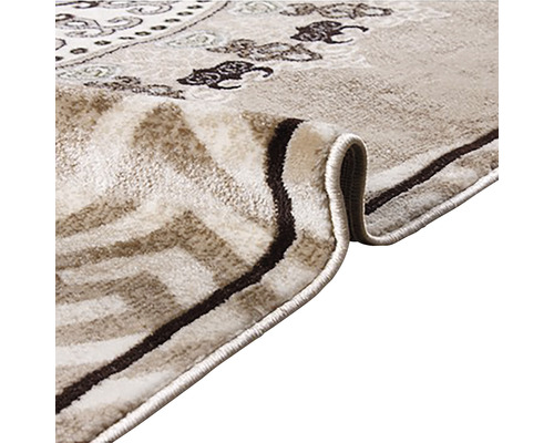 Imagine detaliată a unui covor cu model în bej și maro