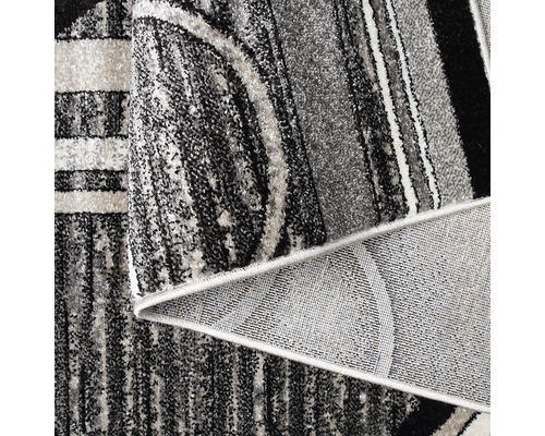 Imagine detaliată a unui covor cu model în diferite nuanțe de gri