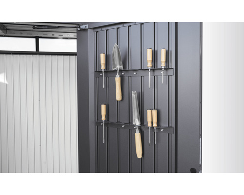 Unelte de grădinărit pe un perete metalic cu suport pentru scule