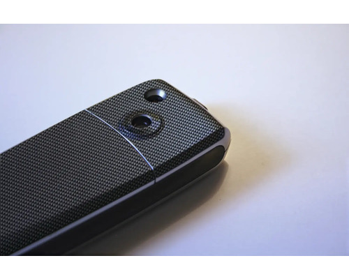 Vizualizare detaliată a unui dispozitiv electronic cu model din fibră de carbon și două scobituri.