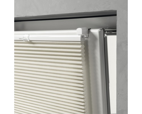 Prim-plan cu jaluzea pliată bej la fereastră