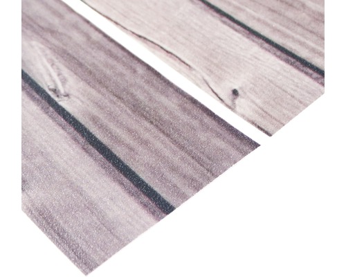 Prim-plan cu folie autoadezivă pentru mobilă cu aspect de lemn