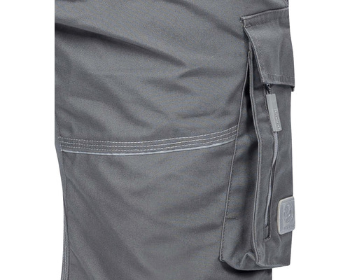 Detaliu al unor pantaloni de lucru cu buzunar cargo și fermoar