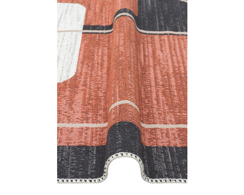 Vizualizare detaliată a unui covor cu model, cu textură țesută și franjuri