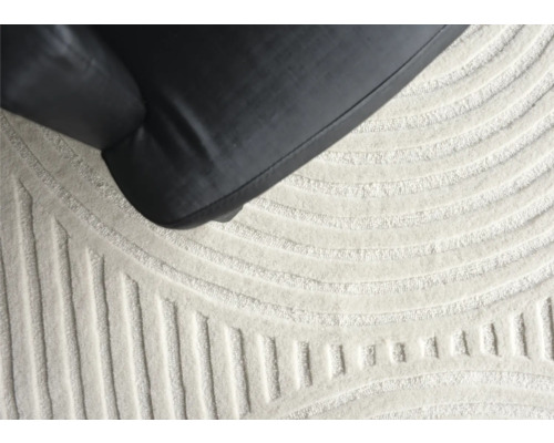 Prim-plan al unui covor cu model geometric și o piesă de mobilier