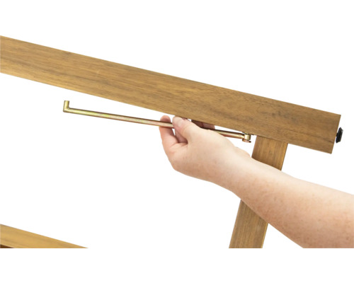 Prim-plan cu o persoană care introduce un știft metalic într-un cadru de lemn