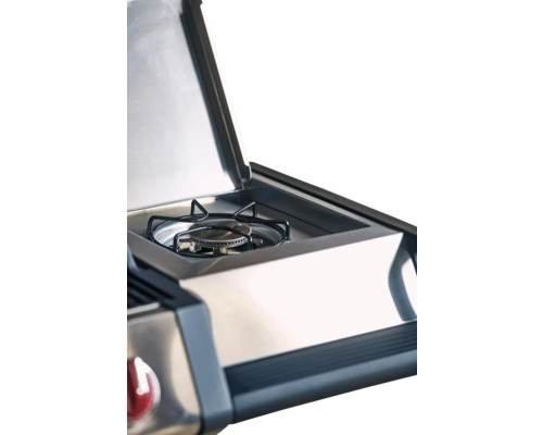 Imagine detaliată a unui grătar pe gaz cu capacul deschis