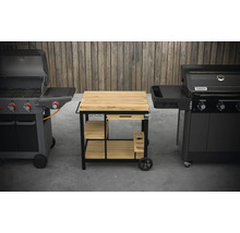 Două grătare pe gaz flanchează o masă de grătar cu sertar și rafturi.