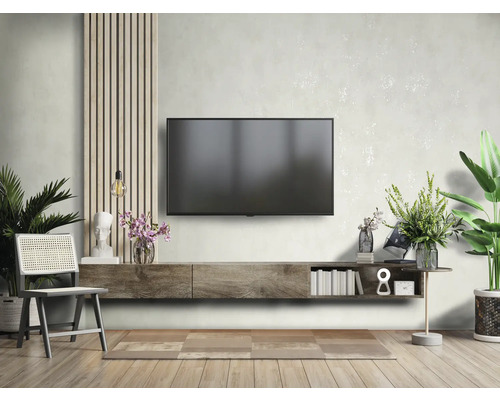 Cameră de zi cu televizor, comodă joasă, scaun și decorațiuni pentru un interior elegant.