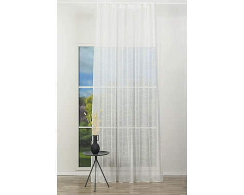 Cameră luminoasă cu ferestre, decorată cu perdele albe transparente și o măsuță laterală cu o vază cu flori.