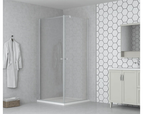 Cabină de duș pe colț cu sticlă transparentă și cadă de duș într-o baie luminoasă