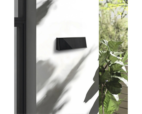 Lampă solară pe un perete pentru exterior.