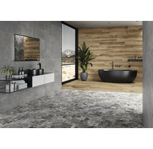 Baie cu gresie gri și maro, chiuvetă, oglindă și cadă independentă.