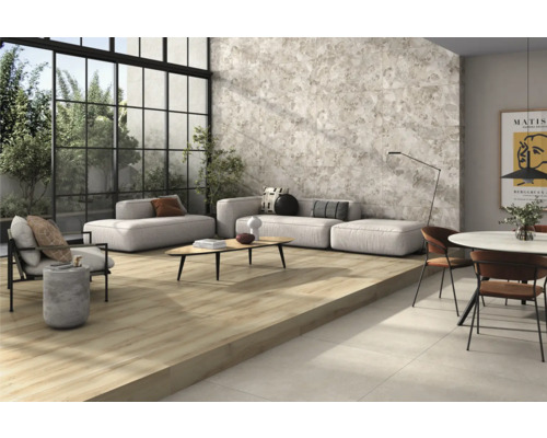 Cameră de zi luminoasă cu gresie cu aspect de lemn, faianță de perete gri și mobilier de ședere