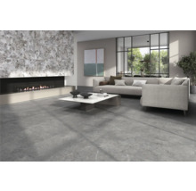 Living cu pardoseală din plăci de piatră, șemineu și canapea gri