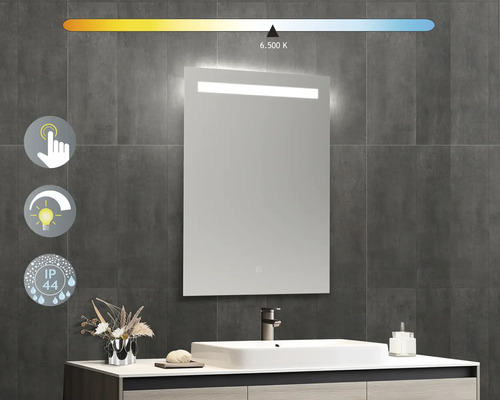 Oglindă de baie iluminată cu senzor tactil și grad de protecție IP44 pe un perete gri