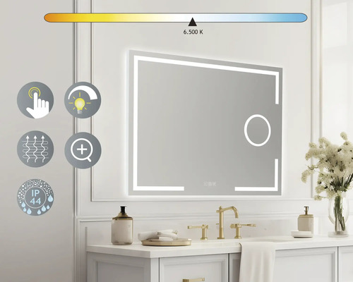 "Oglindă iluminată deasupra unei chiuvete cu robinet auriu și decorațiuni