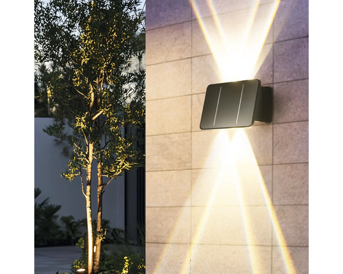 Lampa de perete solară cu raze de lumină pe un perete de casă