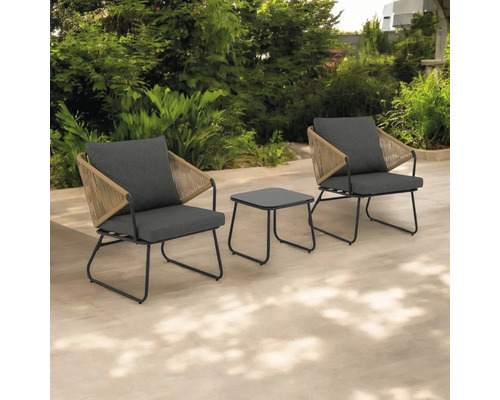 Două scaune de grădină cu o masă pe o terasă în fața unui gard viu verde.