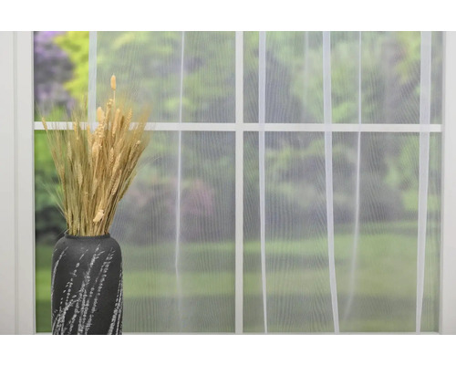 Spice decorative de grâu într-o vază în fața unei ferestre cu perdea