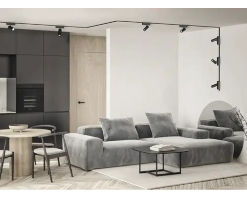 Living modern cu sistem de iluminat pe șină, canapea și masă de sufragerie.