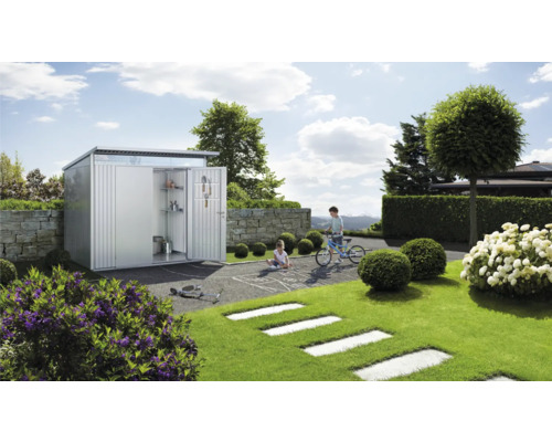 Scenă de grădină cu magazie metalică de grădină, copii care se joacă și gazon