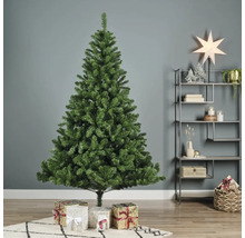 Brad artificial verde de Crăciun cu cadouri în sufragerie.