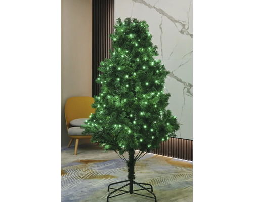 Brad artificial de Crăciun decorat cu iluminare în camera de zi