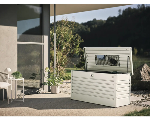 Cutie de grădină metalică deschisă pe o terasă cu vedere la grădină