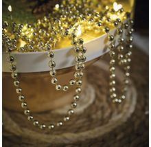 Șirag de mărgele aurii pentru decor într-un bol