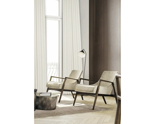 Living cu două fotolii, lampă de podea și perdele la fereastră.