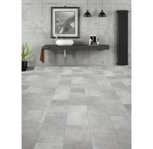 Baie modernă cu lavoar, vas de lavoar, calorifer și podea cu gresie.