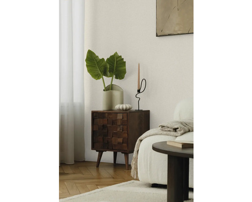 Scenă de living cu comodă din lemn, plantă și suport pentru lumânare
