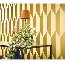 Tapetă decorativă aurie cu model geometric de săgeți într-un interior.