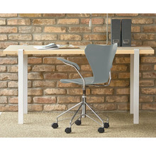 Birou cu scaun de birou în fața unui perete de cărămidă