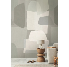 Cameră de zi cu tapet geometric, lampă de masă și canapea