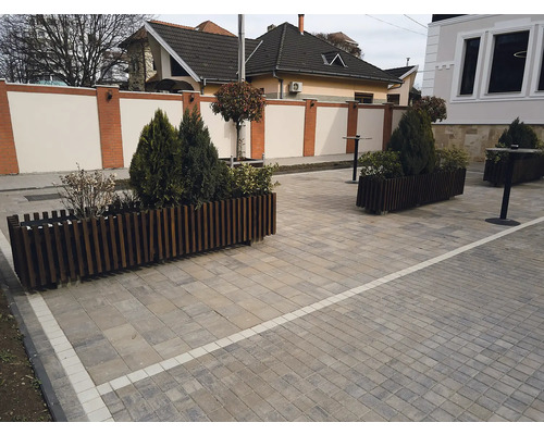Spațiu exterior cu plante în cutii de lemn și podea pavată