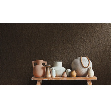 Diverse vaze pe o masă în fața unui perete texturat