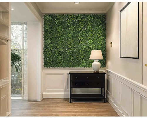 Hol cu perete cu plante, comodă și lampă