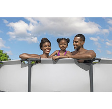 Familie se bucură de înot într-o piscină cu pereți din oțel în grădină