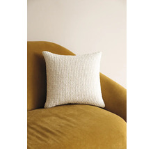 Pernă decorativă pătrată din material textil texturat pe un fotoliu