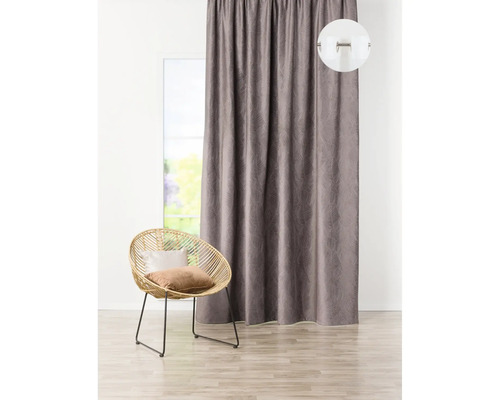 Șaluri decorative cu model lângă o fereastră și un fotoliu